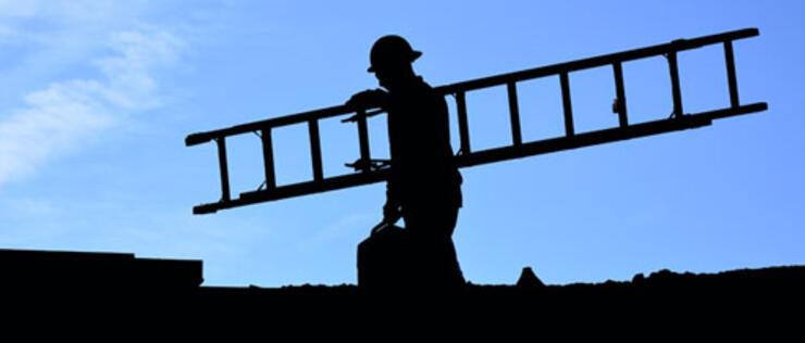 Silhouette of man with ladder